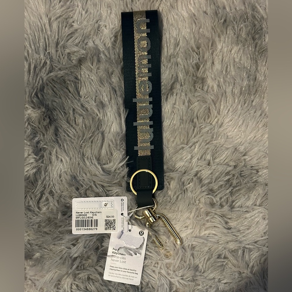 Lululemon green and gold never lost keychain